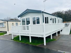 A mobile home with a deck and railing at Cala Gran - The Retreat 256 Boundary Road Fleetwood