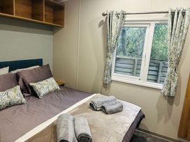 A bedroom with a bed and shelves at Cala Gran - The Retreat 256 Boundary Road Fleetwood