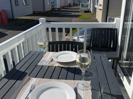 An outdoor dining area with a table set for two at Cala Gran - The Retreat 256 Boundary Road, Fleetwood
