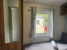 A bedroom with a bed and window at Cala Gran - The Retreat 256 Boundary Road Fleetwood