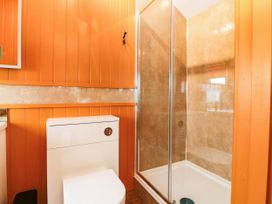 A bathroom with a shower and toilet at Calendonia Hut West Mains near Haggerston