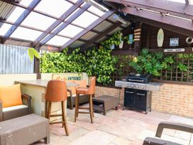 An outdoor seating area with a barbecue grill at Calendonia Hut West Mains near Haggerston