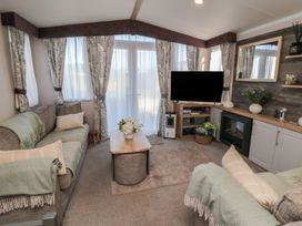A living room with sofa and television at 19 Finch