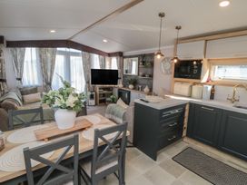 A living room with a sofa and dining area at 19 Finch