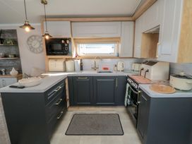 A kitchen with cabinets, sink, stove, and appliances at 19 Finch in 