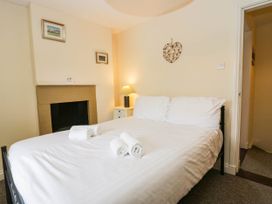 A bedroom with a bed and bedside table at Acorn in Cleator