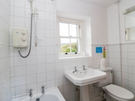 A bathroom with a sink, toilet, and shower at Acorn in Cleator