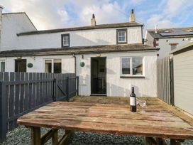 A house with a table and bottle in the yard at Acorn Cleator