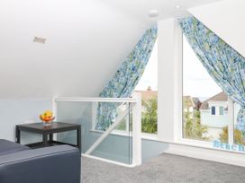 A loft area with a table and fruit bowl at Merlins Hideaway in Dawlish