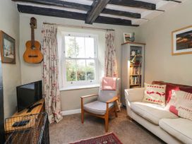 A living room with a guitar on the wall at 2 High Moss House in Broughton-in-Furness