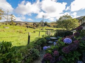 A garden view with a table and chairs at 2 High Moss House in Broughton-in-Furness