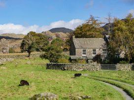 A house with cows in a pasture at 2 High Moss House Broughton-in-Furness