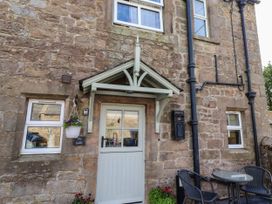 An outdoor area with a front door and seating at The Gables in Alnwick