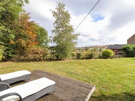 A garden with decking and loungers at The Gables in Alnwick