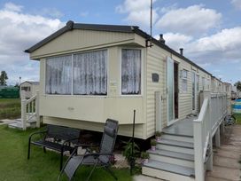 A caravan with steps and a bench at Golden Sands Haven, Sunflower Haven, Mablethorpe