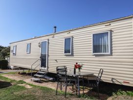 A trailer with a table and chairs outside at Spruces 30 Sandy Bay, Exmouth
