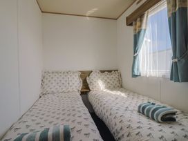 A bedroom with two beds and a window at Spruces 30, Sandy Bay, Exmouth