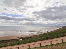 A beach with a pathway and people walking at Spruces 30, Sandy Bay, Exmouth