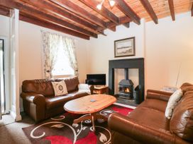 A living room with a sofa and coffee table at Holly in Cleator