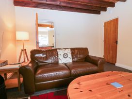 A living room with a sofa and lamp at Holly in Cleator