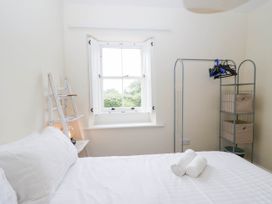A bedroom with a bed and storage items at Holly in Cleator