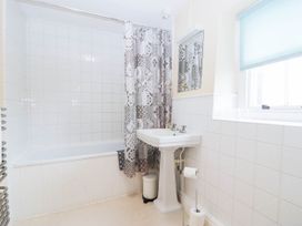 A bathroom with a bathtub and sink at Holly in Cleator