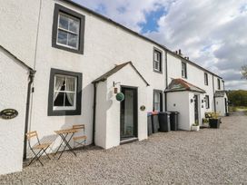 An outdoor area with chairs outside Acorn Cottage in Cleator