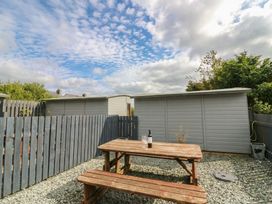 An outdoor area with a table and bottle at Holly in Cleator