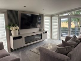 A living room with a television and sofa at Ty Mawr Holiday Park Swift Toronto Lodge in Abergele