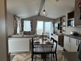 A living room with a dining table and sofa at Club Sahara Sandy Bay, Exmouth