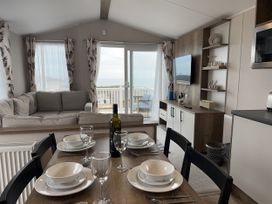 A living room with a sofa and dining table at Club Sahara Sandy Bay, Exmouth