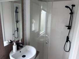 A bathroom with a sink and shower at Club Sahara Sandy Bay, Exmouth