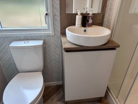A bathroom with a toilet and sink at Club Sahara, Sandy Bay, Exmouth