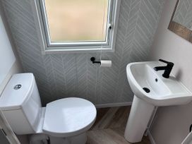 A bathroom with a toilet and sink at Club Sahara, Sandy Bay, Exmouth