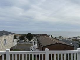 A view of houses and the sea from a deck at Club Sahara in Sandy Bay, Exmouth
