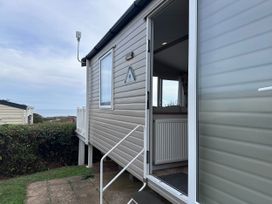 A caravan exterior with steps and a door at Club Sahara Sandy Bay Exmouth