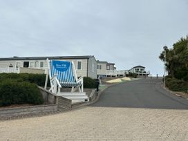 An outdoor area with a large chair and buildings at Club Sahara Sandy Bay, Exmouth