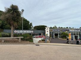 An outdoor area with Slim Chickens and Nisa local at Club Sahara Sandy Bay Exmouth