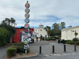 A building with a signpost and people outside at Club Sahara in Sandy Bay, Exmouth