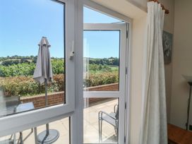 A window and door opening to a patio area at Willow in Kingsteignton