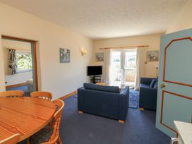 A living room with a sofa and table at Willow in Kingsteignton
