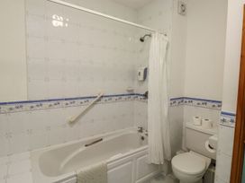 A bathroom with a bathtub and shower at Willow in Kingsteignton