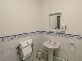 A bathroom with a sink and mirror at Willow in Kingsteignton