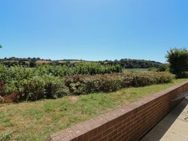 A view of fields and bushes in the landscape at Willow in Kingsteignton