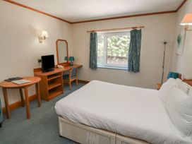 A bedroom with a bed and desk at Tor in Kingsteignton