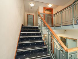 A stairwell with a staircase and a door at Goldfinch in Kingsteignton