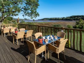 An outdoor seating area with tables and chairs at Goldfinch in Kingsteignton