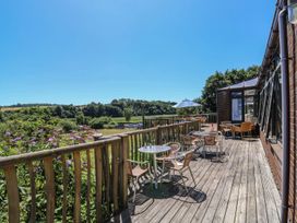 A terrace with outdoor seating and a view at Moorland in Kingsteignton