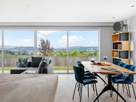 A living room with a dining area and views at Huxham View & Annex in Kingsteignton