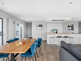 A dining room with a table and chairs at Huxham View & Annex Kingsteignton
